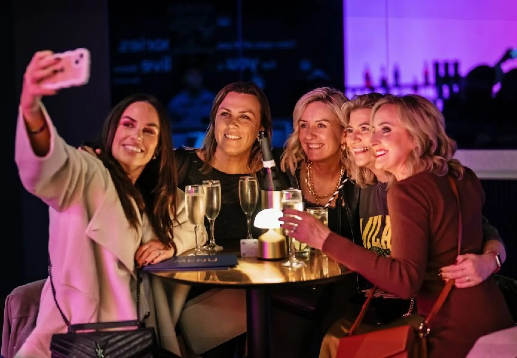 A group of happy customers taking a selfie in the Sky Lounge tunnel at The SSE Arena Belfast