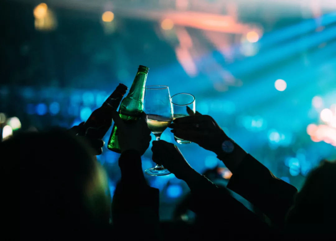 Fans enjoying drinks during a concert at the arena.